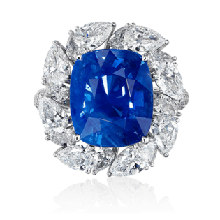 Ring with a 12.21-carat ‘No Heat’ ‘Cornflower’ blue Sri Lankan sapphire centre gem surrounded by diamonds. The sapphire comes with a GRS report Goko Shokai Co Ltd